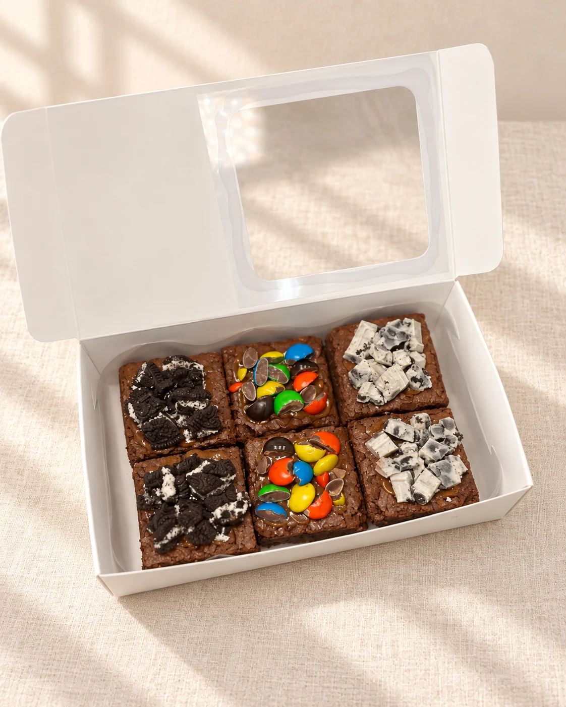 Caja de seis brownies con toppings de Oreo y chocolates de colores